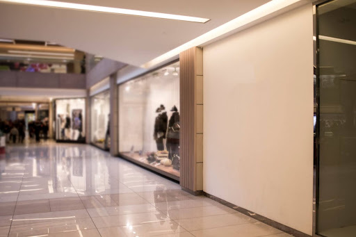 A picture of an empty hallway in a shopping mall.